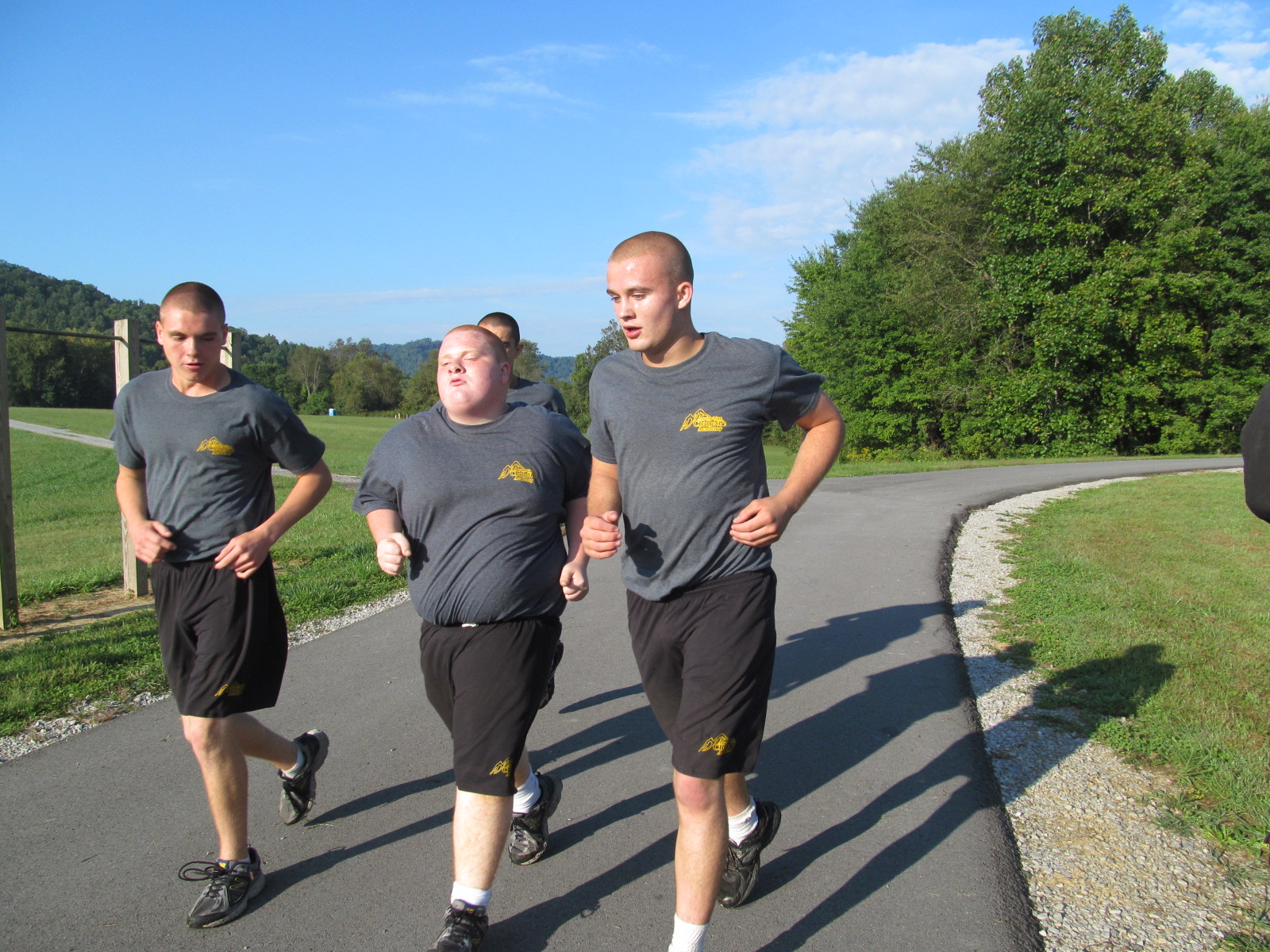 Cadets supporting each other as they run their PT test